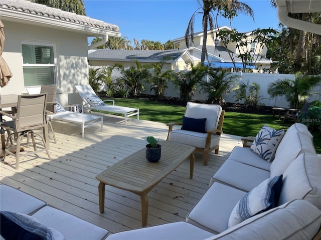 wooden deck featuring outdoor lounge area and a yard