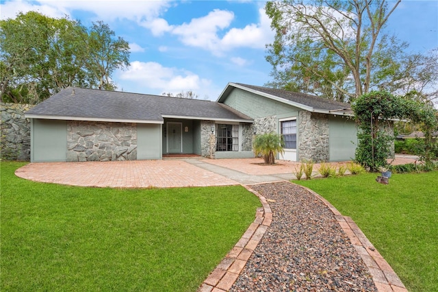 ranch-style home with a front yard and a patio