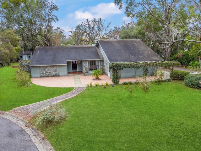 ranch-style home with a front lawn and covered porch