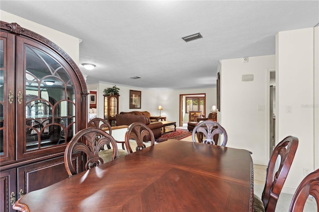 dining space with a textured ceiling