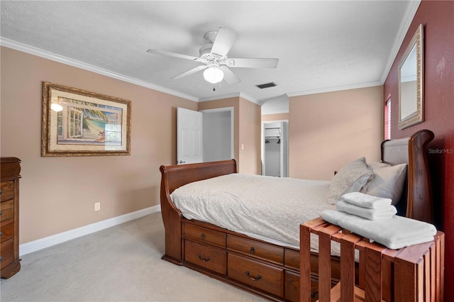 carpeted bedroom with ceiling fan, a closet, and crown molding