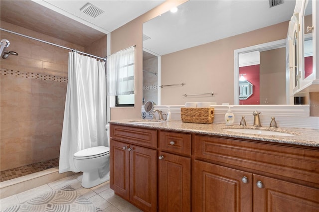 bathroom with curtained shower, toilet, vanity, and tile patterned flooring