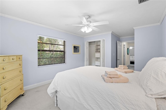 carpeted bedroom featuring a spacious closet, ceiling fan, ornamental molding, and a closet