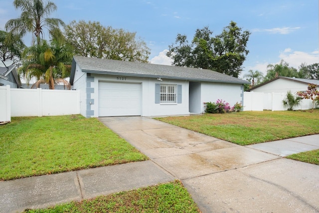 single story home with a garage and a front lawn