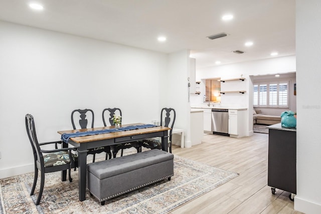 dining area with light hardwood / wood-style flooring