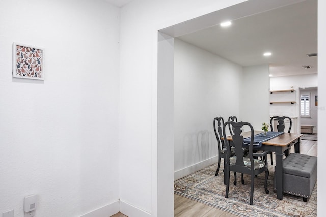 dining space with wood-type flooring