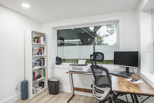 office with light wood-type flooring