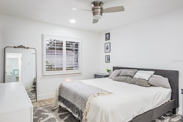 bedroom with wood-type flooring and ceiling fan