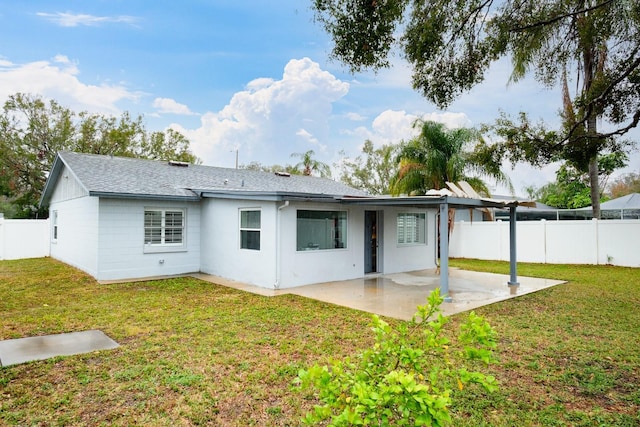 back of house with a patio area and a lawn