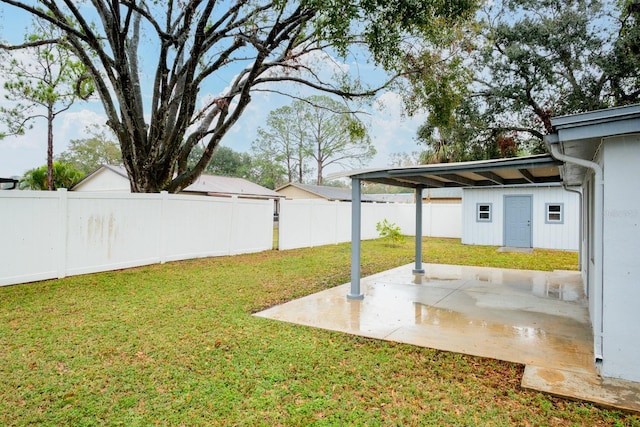 view of yard with a patio and an outbuilding