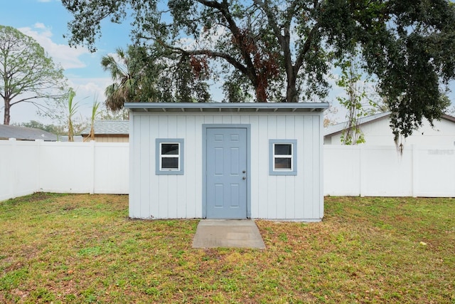 view of outbuilding with a yard