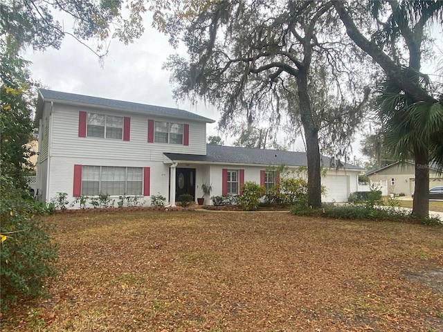 view of front of house with a garage and a front yard