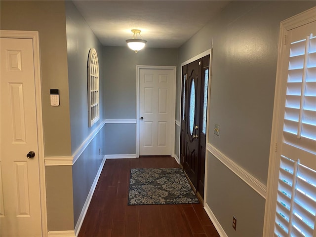 doorway to outside with dark wood-style flooring and baseboards