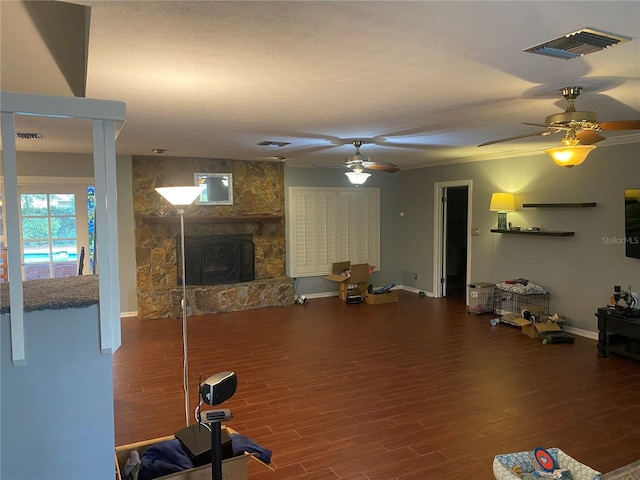 workout area with visible vents, a fireplace, and wood finished floors