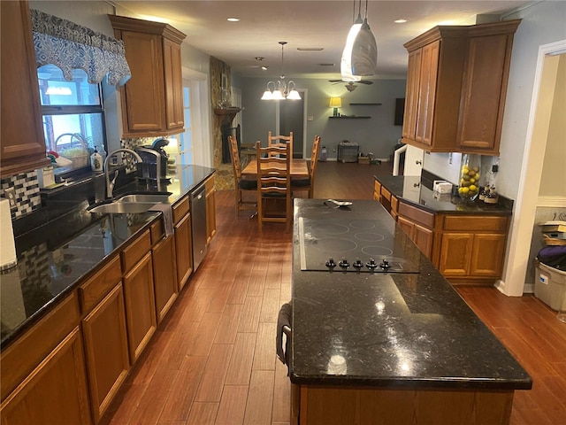 kitchen with brown cabinetry, dishwasher, dark wood-style floors, black electric stovetop, and a sink