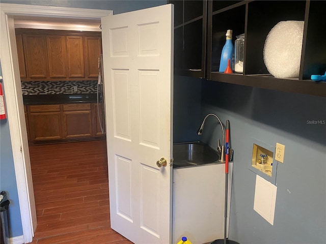 laundry room featuring a sink, laundry area, hookup for a washing machine, and dark wood-style floors