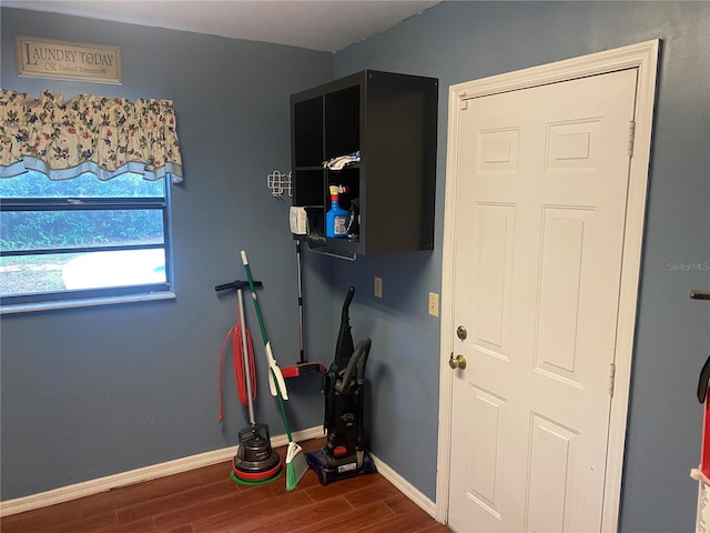 interior space with wood finished floors and baseboards