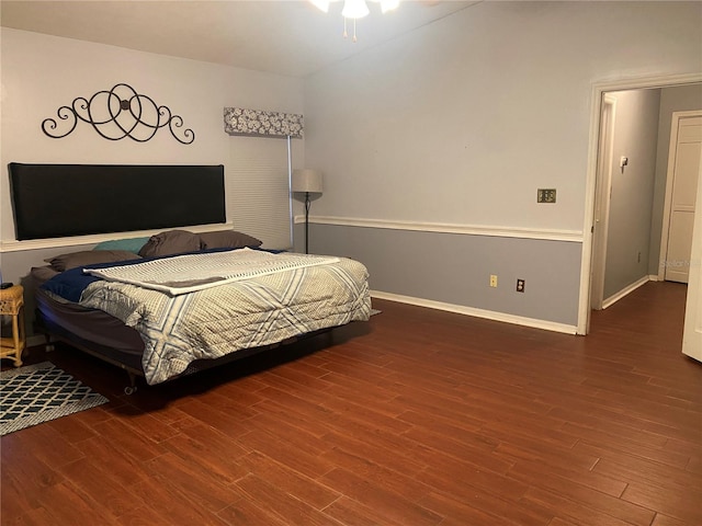 bedroom with baseboards and wood finished floors