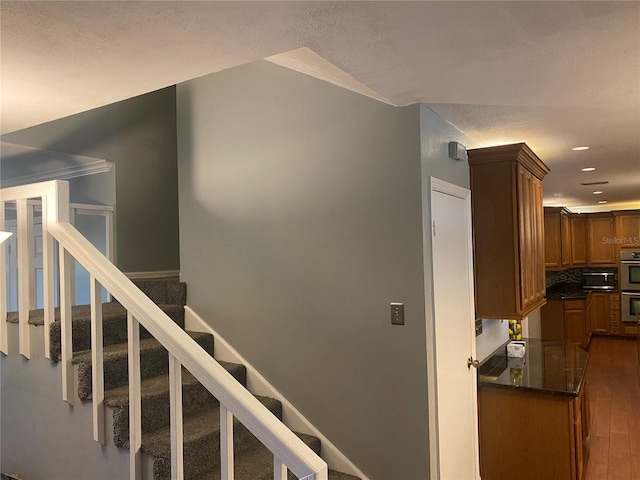 stairs featuring wood finished floors