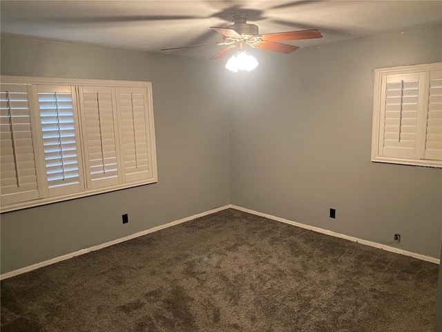 carpeted spare room with baseboards and a ceiling fan