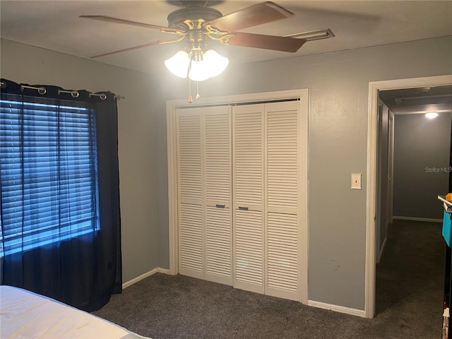 unfurnished bedroom with a ceiling fan, a closet, carpet flooring, and baseboards