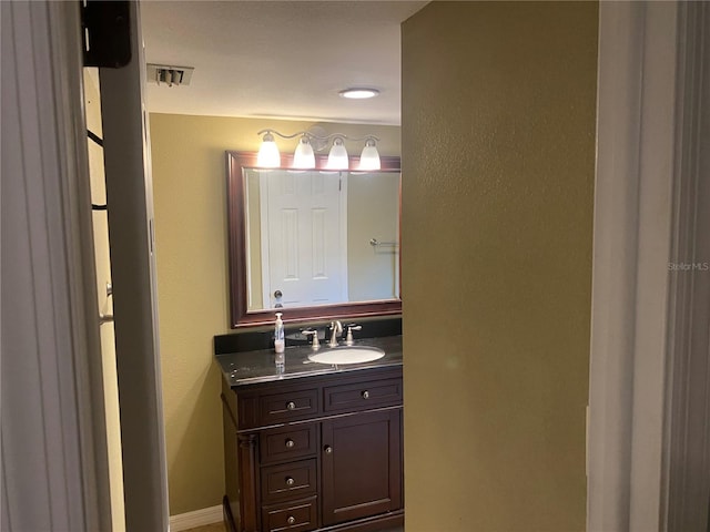 bathroom with visible vents and vanity