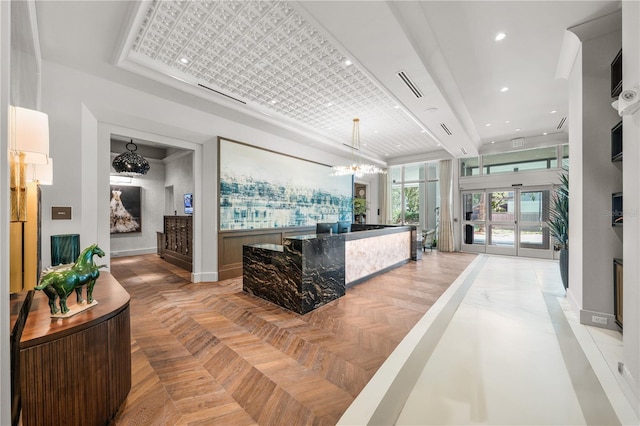 welcome area featuring a chandelier and french doors