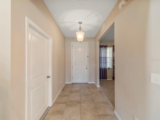 corridor with light tile patterned flooring