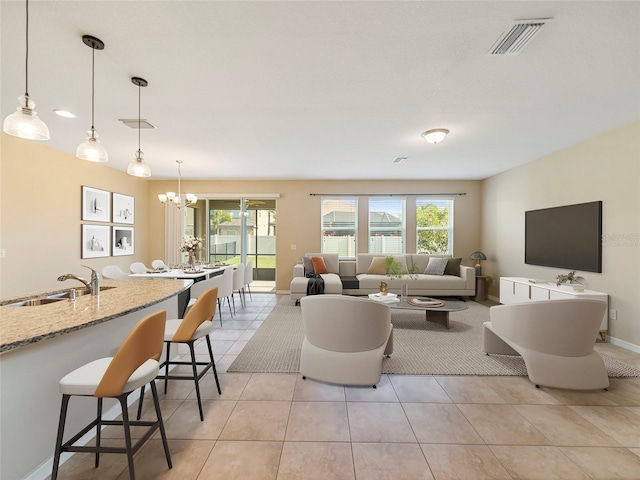 tiled living room with sink, a wealth of natural light, and a notable chandelier