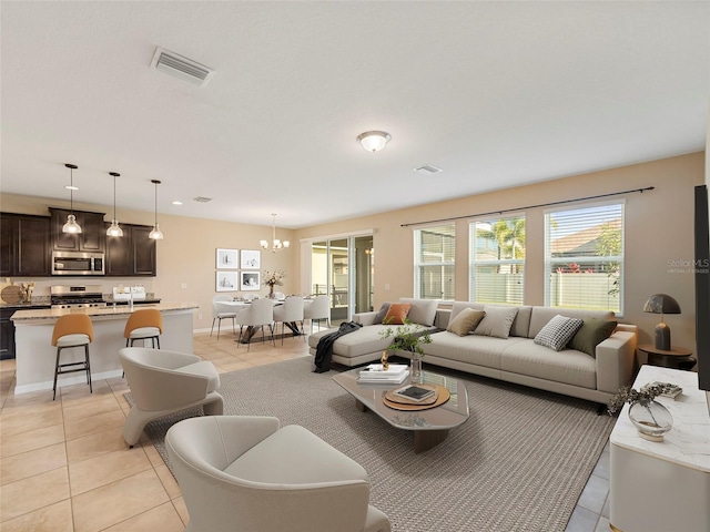 tiled living room featuring an inviting chandelier