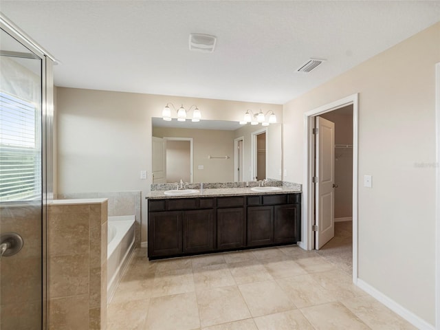 bathroom with tile patterned floors, vanity, and plus walk in shower