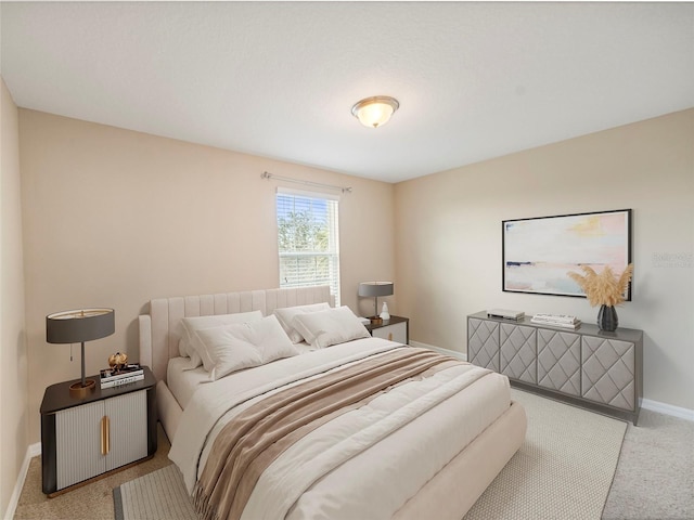 bedroom featuring light carpet