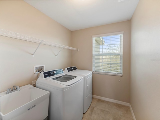 washroom with sink and independent washer and dryer