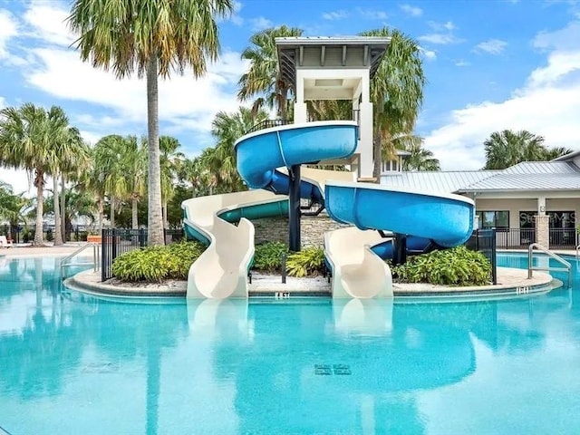 view of swimming pool with a water slide