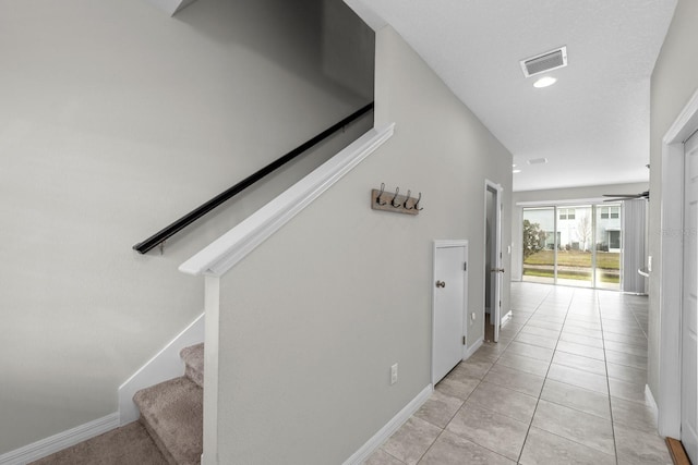 corridor featuring light tile patterned floors