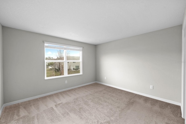 unfurnished room featuring light colored carpet