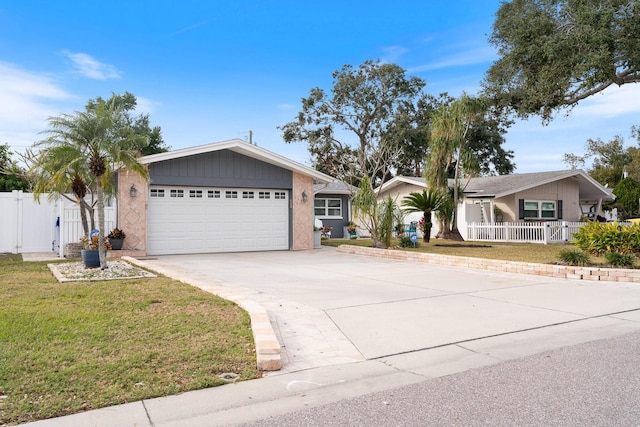 single story home with a garage and a front lawn