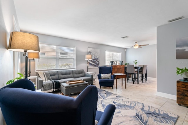 tiled living room with ceiling fan