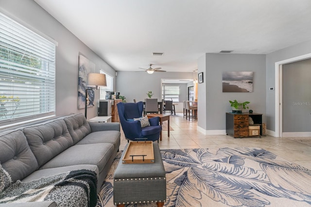 tiled living room featuring ceiling fan