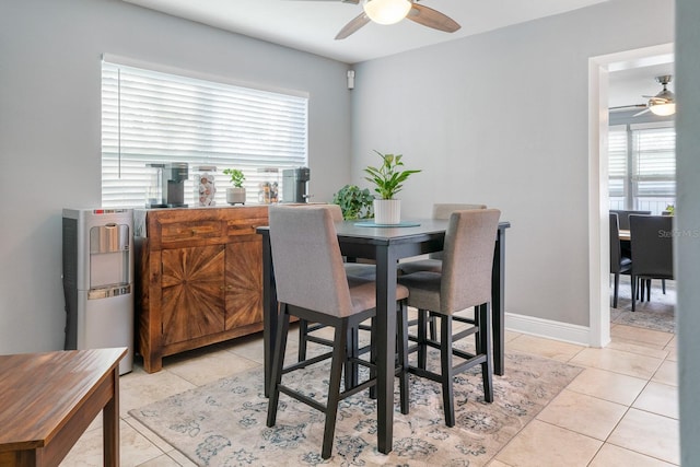 dining room with ceiling fan and light tile patterned flooring