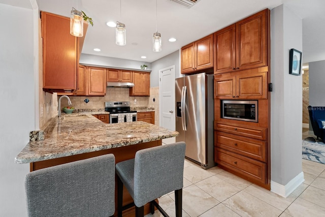 kitchen featuring appliances with stainless steel finishes, tasteful backsplash, hanging light fixtures, sink, and light tile patterned flooring