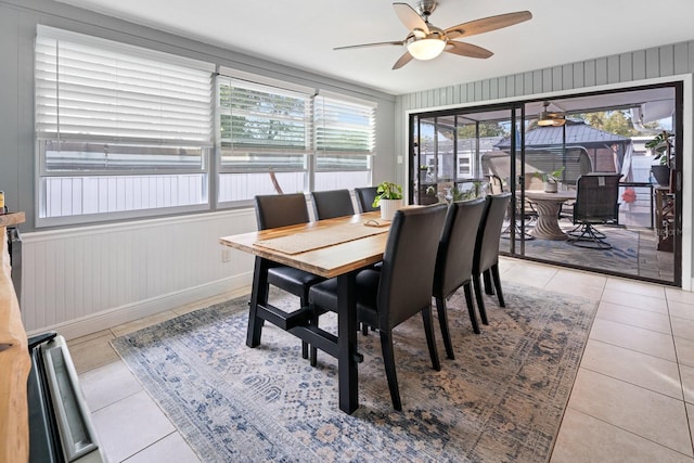 tiled dining space with ceiling fan