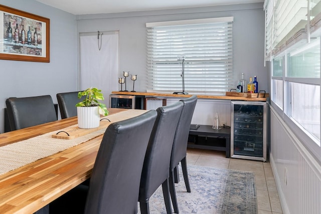 tiled dining room with bar area and beverage cooler