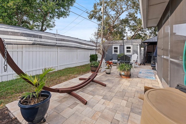 view of patio / terrace featuring a gazebo and a shed