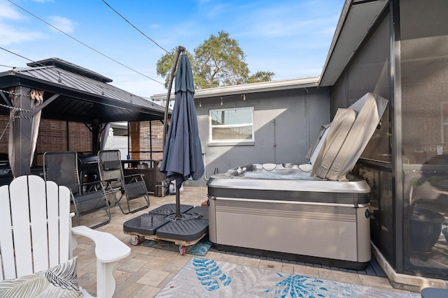 view of patio with a gazebo and a hot tub