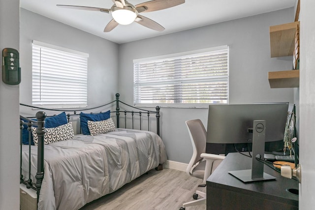 bedroom featuring light wood-type flooring and ceiling fan