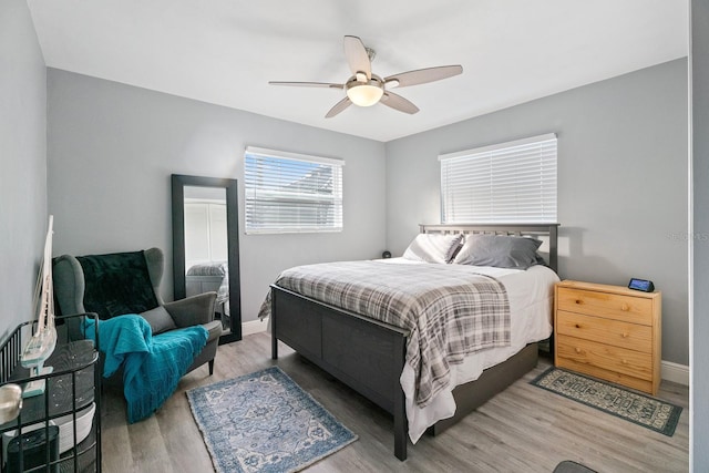 bedroom with hardwood / wood-style flooring and ceiling fan