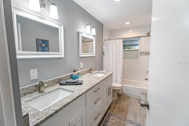 full bathroom featuring vanity, toilet, shower / bathtub combination with curtain, and wood-type flooring