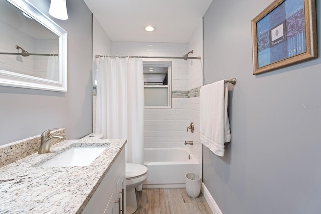 full bathroom featuring vanity, toilet, shower / bathtub combination with curtain, and wood-type flooring