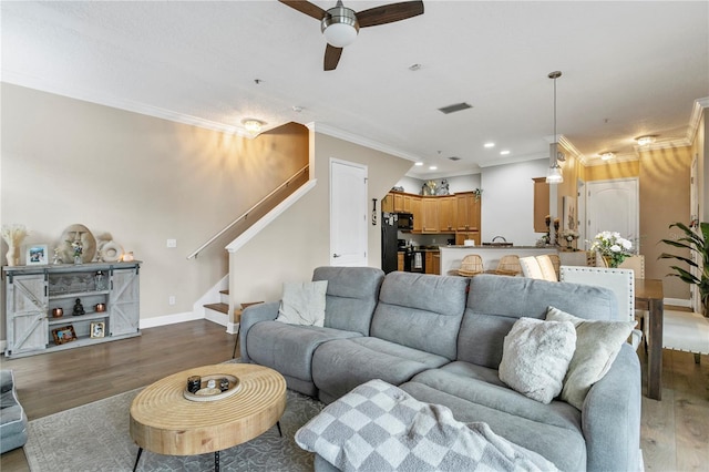 living room featuring ornamental molding, ceiling fan, and hardwood / wood-style floors